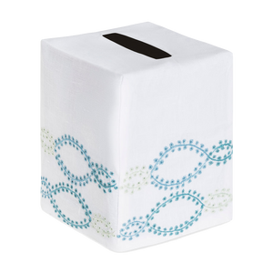 The Foam Bath Collection, Aqua by Haute Home features a hand-embroidered tissue box cover with decorative blue and green swirl patterns on Italian linen and a sleek black dispensing slit for easy access.