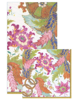 Two eco-friendly, triple-ply Caspari napkins from the Tobacco Leaf Ivory Collection featuring overlapping floral and leaf patterns in pink, orange, green, and blue on a white background.