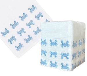 The Haute Home Mini Crab Bath Collection in Blue features a white Italian linen napkin and tissue box cover, each hand-embroidered with cute blue crab designs.