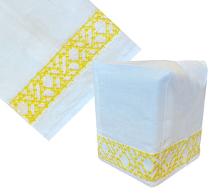 The Lido Bath Collection, Yellow by Haute Home features white Italian linen with a yellow geometric hand-embroidered border, displayed both flat and as a tissue box cover for rectangular boxes.