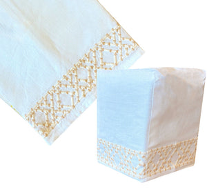 The Haute Home Lido Bath Collection in Cream includes a linen tablecloth and tissue box cover, both adorned with a beige hand-embroidered border.