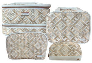 Four beige and white travel bags from the Paros Coconut Travel Collection by Stephanie Johnson are shown together, each with a woven diamond pattern, zip closures, and popular styles like the Jenny Train Case and Mae Mini Pouch.
