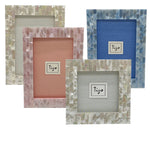 The Mother of Pearl Frame Collection by Tizo Design features four unique frames with mosaic borders in white, pink, and blue tones. Each frame’s distinct background brings iridescent magic to your gallery wall.