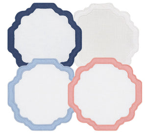 The Haute Home Scallop Coaster Set includes 4 coasters in navy, white, light blue, and pink with scalloped edges and hand embroidery, arranged in a grid pattern on a white background for an artisanal touch.