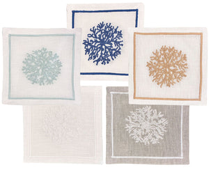 The Haute Home Sea Sponge Coaster Set includes 4 linen coasters, each hand embroidered with coral designs in blue, beige, light blue, white, and gray for a refined touch at your gatherings.