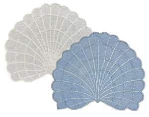 The Haute Home Shell Coaster Set features two shell-shaped coasters—one white, one blue—with embroidered detailing, overlapping on a plain background for a charming coastal décor accent.