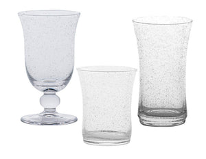 Three clear glasses from the Juliska Provence Basil Drinkware Collection, each with a unique bubbled texture and different shapes and sizes, are displayed against a white background.