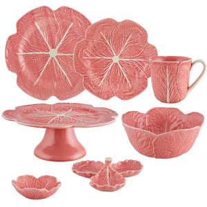 The Pink Cabbage Leaf Dinnerware and Serveware Collection by Hive features ceramic plates, bowls, a mug, cake stand, and divided serving dish with leaf-inspired designs in a Pink Edition.