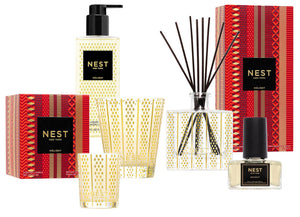 Celebrate with the NEST Holiday Collection by Nest, featuring a scented candle, reed diffuser, hand soap, and fragrance—all in festive gold and red packaging with their signature Holiday scent.