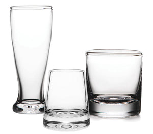 Three clear, empty glass cups of various shapes and sizes from the Simon Pearce Ascutney Drinkware Collection are displayed against a plain white background, highlighting this exquisite handmade barware.