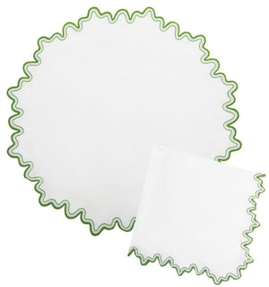 The Wave Tabletop Collection, Santorini by Matouk features round and square white linen napkins with wavy green-edged borders, OEKO-TEX certified—perfect for layering on embroidered tabletops.