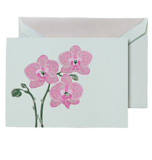 The Crane Violet Orchid Folded Card Set features an exotic orchid illustration on the front, matched with a light-colored envelope and printed on elegant Beach Glass paper.