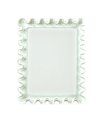 The Wave Moderne Mirror in White by Carvers' Guild features a rectangular beveled glass and a wavy, ruffled frame in an Art Deco style, displayed against a plain white background.