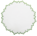 The Wave Tabletop Collection in Santorini by Matouk features a round white linen placemat with a wavy green border, ideal for an elegant embroidered table. OEKO-TEX certified for your peace of mind.