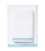 Two folded Averylily Weave Bath Collection towels, one large and one small, with decorative blue geometric borders, rest on a white background. Ultra-absorbent Aegean Cotton for daily use.