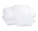 A folded white towel from the Matouk Whipstitch Bath Collection, made with soft, textured Cairo long-staple cotton, is displayed against a plain white background.