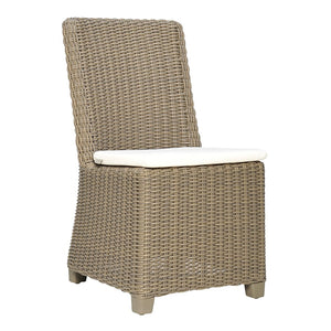 The Zeya Outdoor Dining Side Chair by Janus et Cie features weather-resistant wicker, a high back, square seat, and a white cushion—ideal for stylish al fresco dining.