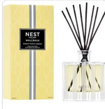 A box and a glass Nest Sunlit Yuzu & Neroli Reed Diffuser with black reeds, both labeled “Nest,” featuring the aroma of yuzu and neroli.