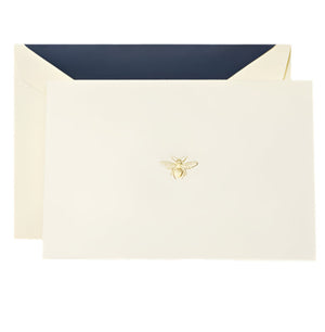 Crane's Bee Classic Card Set includes an ecru card and envelope with a gold bee emblem and dark blue lining, all set on a white background—ideal for sending thoughtful handwritten notes.