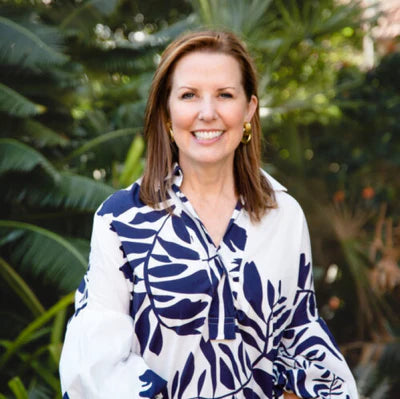portrait of Sara McCann wearing blue and white dress