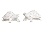 The Clever Creatures Turtle Salt and Pepper Set by Juliska features two white ceramic turtles with textured shells, positioned side by side and believed to bring wisdom and good luck—an ideal accent for entertaining enthusiasts.