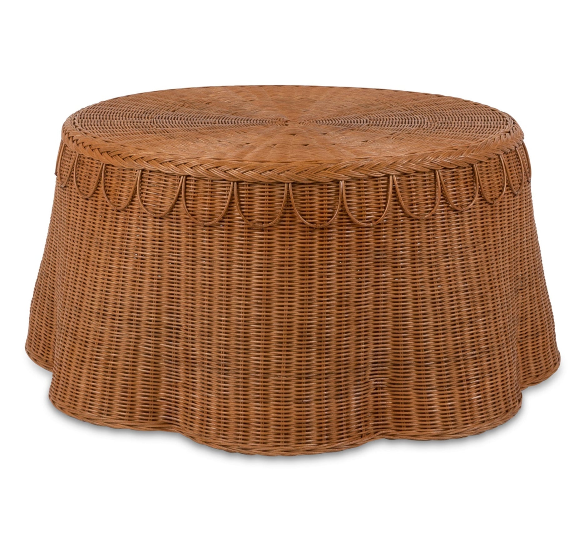 The Adeline Coffee Table by Sharland England features a round, flat top with a decorative scalloped edge, handmade in natural brown wicker—bringing signature charm to your living space.