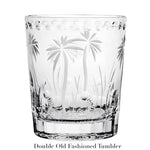 A clear glass tumbler with hand-cut palm tree and grass designs, labeled "Double Old Fashioned Tumbler" beneath; part of the handmade Alexis Collection by William Yeoward Crystal.