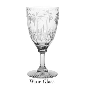 The William Yeoward Crystal Alexis Collection features exquisite handmade crystal glasses with intricate plant engravings on the bowl and a decorative stem and base, highlighting meticulous hand-cut detailing.