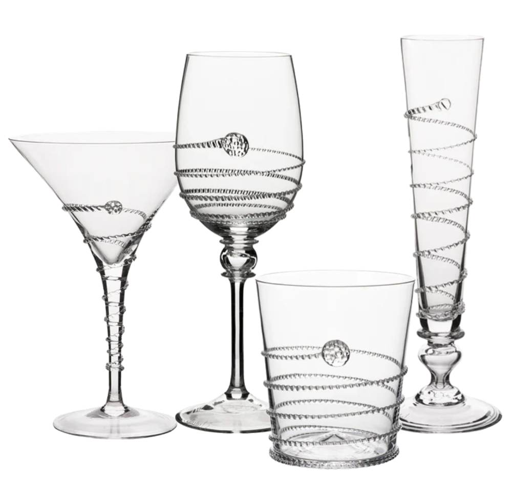 The Amalia Drinkware Collection by Juliska features four types—martini glass, wine glass, tumbler, and champagne flute—with intricate spiral ribbon and glass bead designs, all handcrafted by master artisans.