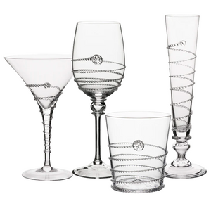 The Amalia Drinkware Collection by Juliska features four types—martini glass, wine glass, tumbler, and champagne flute—with intricate spiral ribbon and glass bead designs, all handcrafted by master artisans.