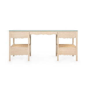 The Arianna Desk by Villa & House features cerused oak, a glass top, two central drawers, and open side shelves with woven rattan surfaces, shown against a white background.