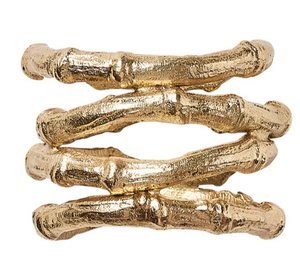The Kim Seybert Gold Bamboo Napkin Ring features elegant gold plating and a design inspired by faux bamboo, resembling three stacked, textured branches for a sophisticated table accent.