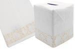 The Bamboozle Bath Collection, Cream by Haute Home, features a white Italian linen tissue box cover elegantly detailed with beige hand embroidery at the bottom edge, accompanied by a matching linen napkin with similar intricate embroidery.