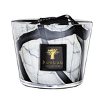The Baobab Collection Stones Marble Candle by Baobab comes in a hand-blown grey marble-patterned black and white glass holder, with a black and gold label on the front and a black ribbon tied on top.
