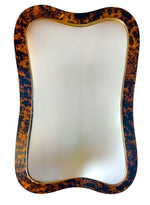The Alegro Mirror in Tortoise by Carvers' Guild features a rectangular shape with a wavy tortoise shell-patterned frame and elegant gold edge, displayed against a white background.