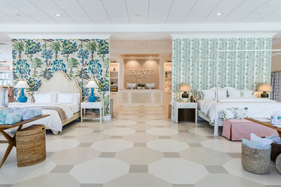 inside of hive bed and bath with 2 bedroom vignettes and the store cashwrap in the background