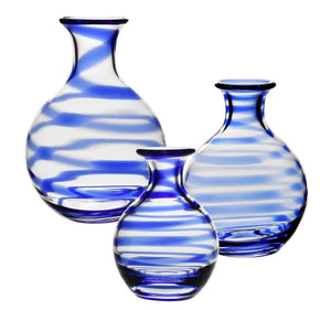 Three clear glass carafes from the William Yeoward Crystal Bella Blue Carafe Collection, featuring blue and white stripes, are arranged on a white background. Proposition 65 warning: may expose you to chemicals known in California.