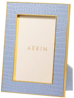 The Classic Croc Leather Frame Collection by Aerin is a rectangular blue photo frame with a gold border, crafted from Italian croc-embossed leather, featuring a placeholder card that says "AERIN.