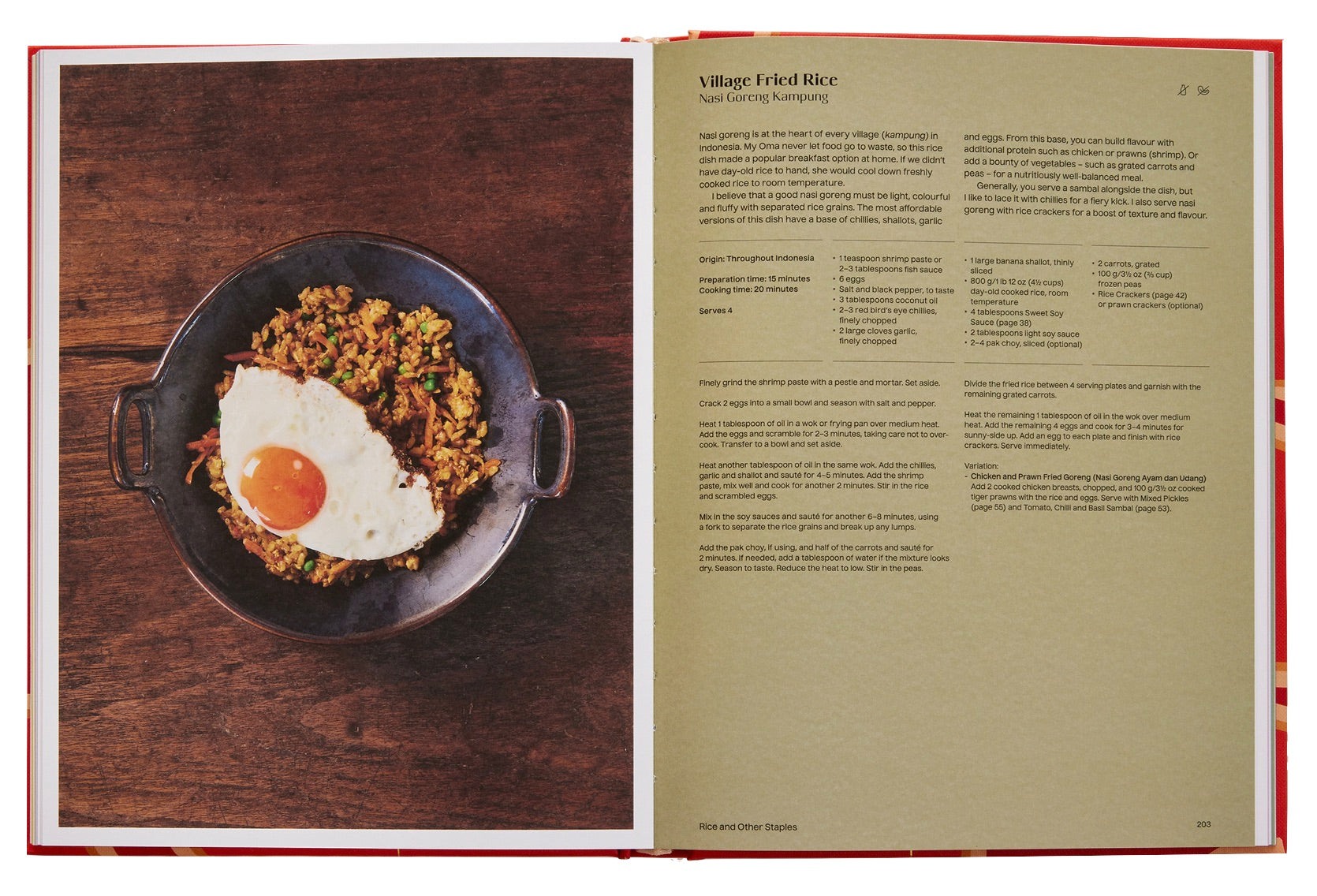 A Phaidon The Indonesian Table cookbook spread with a recipe for "village fried rice" on the right page, and a photograph of the dish served in a pan with an egg on top on the left page.