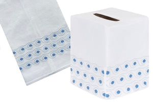 The Breakers Bath Collection in Blue by Haute Home features a white Italian linen tissue box cover and matching towel, each hand-embroidered with blue wave-like edges.