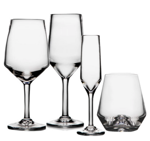 Four clear pieces from the Simon Pearce Bristol Drinkware Collection—two wine glasses, one champagne flute, and one stemless glass—are displayed on a white background, highlighting Northeast Islander-inspired elegance and Golden Ratio balance.