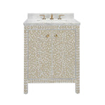 The Azalea Vanity Collection by Made Goods features a beige and white floral inlay with mother-of-pearl accents, gold hardware, soft-close drawers, plus a white countertop with integrated sink and gold faucet.