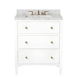 The Jarin Vanity Collection by Made Goods features a white floating vanity with three drawers, gold knobs, a marble countertop, and gold faucet fixtures for a modern bathroom update.