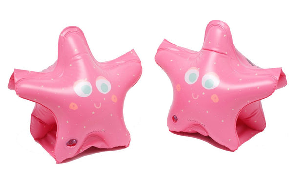 Two Sunnylife Buddy Float Bands in pink color, star-shaped inflatable swimming accessory toys with cute face designs on a white background, made from non-toxic phthalate-free PVC.
