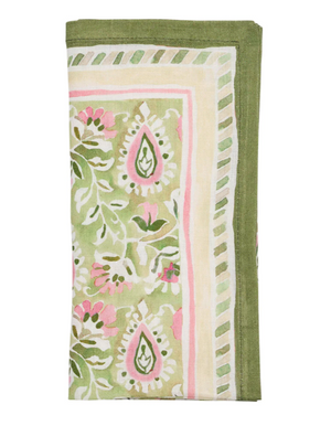 The Mira Napkin Set by Kim Seybert features folded linen napkins with a green, pink, and white floral and geometric paisley pattern, finished with a green border.