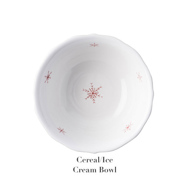 From above: A white ceramic bowl with scalloped edges and red snowflake designs from Juliska's Country Estate Winter Frolic Ruby Dinnerware Collection. Text below: "Cereal/Ice Cream Bowl.