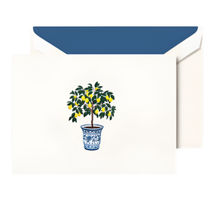 The Crane Potted Lemon Tree Card Set showcases a white card with a potted lemon tree in a blue and white pot, paired with a matching envelope with blue lining—Mediterranean elegance on premium-quality paper.