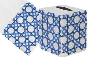 Haute Home's Cane Bath Collection, Blue, includes a white Italian linen tissue box cover with a hand-embroidered blue geometric pattern, paired with a matching napkin.