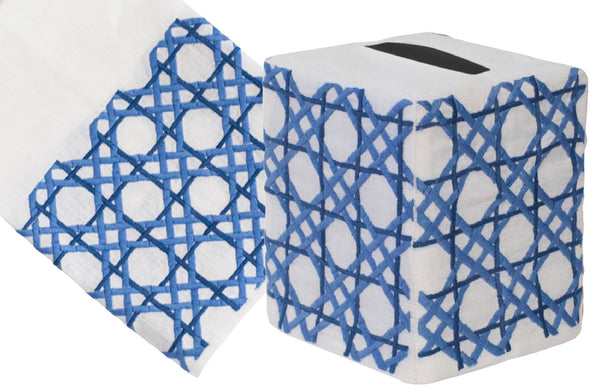 Two rolls of Cane Collection, Blue linen towels with a blue geometric design, one roll partially unrolled, isolated on a white background. Brand Name: Haute Home