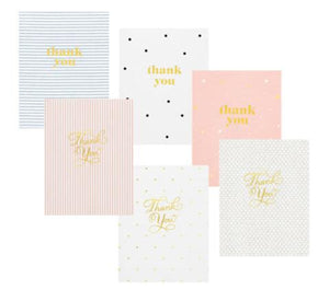 The Sugar Paper Thank You Card Box Set includes six assorted pastel cards with gold foil lettering in stripes, dots, and polka dot designs. Comes in a storage box, keeping your thank you cards organized and ready for any occasion.